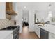Updated kitchen featuring a stainless steel range, white cabinets, and hardwood floors at 1358 Peppergrass Nw Trl, Acworth, GA 30101