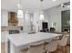 Bright kitchen features a large island with white countertop, pendant lighting and modern appliances at 1358 Peppergrass Nw Trl, Acworth, GA 30101