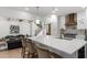 Open-concept kitchen features an island with seating, white cabinets, and stainless steel appliances at 1358 Peppergrass Nw Trl, Acworth, GA 30101