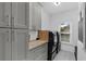Well-organized laundry room with gray cabinets, ample storage, butcher block countertop, and modern appliances at 1358 Peppergrass Nw Trl, Acworth, GA 30101