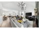 Bright living room featuring a large gray sofa, soaring ceilings, and modern decor throughout the open-concept space at 1358 Peppergrass Nw Trl, Acworth, GA 30101