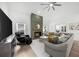 Cozy living room with a fireplace, large sectional sofa, and ample natural light at 1358 Peppergrass Nw Trl, Acworth, GA 30101