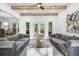 Cozy living room featuring hardwood floors, wood beams, and access to a patio at 1358 Peppergrass Nw Trl, Acworth, GA 30101