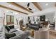 Open-concept living space featuring wood beams, hardwood floors, and modern decor at 1358 Peppergrass Nw Trl, Acworth, GA 30101