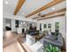 Open-concept living area with wood beam ceilings, hardwood floors, and transitional furniture at 1358 Peppergrass Nw Trl, Acworth, GA 30101