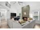 Living room with a large gray couch, fireplace with green trim and high ceilings at 1358 Peppergrass Nw Trl, Acworth, GA 30101