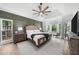 Serene primary bedroom with a tray ceiling, a bay window seating area, and calming neutral color palette at 1358 Peppergrass Nw Trl, Acworth, GA 30101