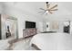 Spacious primary bedroom with a large TV, decorative cabinet, walk-in closet, and calming white walls at 1358 Peppergrass Nw Trl, Acworth, GA 30101