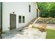 Side patio with stone pavers, outdoor seating, and garden beds offers a private retreat at 1358 Peppergrass Nw Trl, Acworth, GA 30101