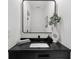Stylish powder room featuring a black vanity, modern sink, and elegant decor with a square black framed mirror at 1358 Peppergrass Nw Trl, Acworth, GA 30101