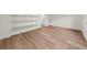 A large room with wood flooring, white walls, and built-in shelving at 1358 Peppergrass Nw Trl, Acworth, GA 30101