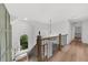 Open staircase with decorative railings and bench in front of an arched window at 1358 Peppergrass Nw Trl, Acworth, GA 30101
