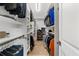 Organized walk-in closet with ample shelving, hanging rods, and storage space for clothing and accessories at 1358 Peppergrass Nw Trl, Acworth, GA 30101
