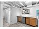 Basement kitchenette with wood cabinets, stainless fridge, tiled floor and marble counters at 3294 Mcclure Bridge Rd, Duluth, GA 30096