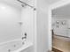 A bathroom featuring a tiled shower and bathtub with a view into the bedroom at 3294 Mcclure Bridge Rd, Duluth, GA 30096