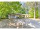 Charming single-story home with a spacious front yard and lush greenery creating a serene setting at 3294 Mcclure Bridge Rd, Duluth, GA 30096