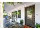Inviting front porch with rocking chairs, potted plants, and a stylish front door at 3294 Mcclure Bridge Rd, Duluth, GA 30096