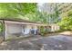 Inviting white brick home featuring an open carport and cozy front porch with seating at 3294 Mcclure Bridge Rd, Duluth, GA 30096