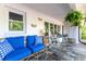 Cozy front porch with comfortable seating, decorative butterflies, and ferns for a relaxing atmosphere at 3294 Mcclure Bridge Rd, Duluth, GA 30096