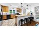 Kitchen features wooden cabinets, a tile floor, bar stool seating, and modern appliances at 3294 Mcclure Bridge Rd, Duluth, GA 30096