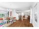 Open living space features a colorful rug, wood floors, dining area, and bright, natural light at 3294 Mcclure Bridge Rd, Duluth, GA 30096