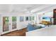 Cozy living room with a blue couch, wood floors, a TV, and a view to the back deck at 3294 Mcclure Bridge Rd, Duluth, GA 30096