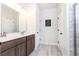 Bright bathroom featuring a double sink vanity, marble floor, and glass shower stall at 500 Garvin Dr, Woodstock, GA 30189
