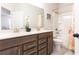 Bright bathroom with double sink vanity, tile floors, and a shower/tub combo with printed shower curtain at 500 Garvin Dr, Woodstock, GA 30189
