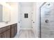 Bright bathroom featuring a double sink vanity, marble floor, and glass shower stall at 500 Garvin Dr, Woodstock, GA 30189