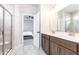 Bright bathroom showcasing a double sink vanity, glass shower stall and a view into bedroom at 500 Garvin Dr, Woodstock, GA 30189
