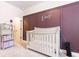 Cozy Bedroom showcasing paneled accent wall with white crib and bookshelf, creating a serene atmosphere at 500 Garvin Dr, Woodstock, GA 30189