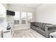 Comfortable bonus room features a plush sofa, natural light, and play area at 500 Garvin Dr, Woodstock, GA 30189