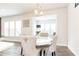 Light-filled dining area features modern chandelier and artwork with ample seating for Gathering gatherings at 500 Garvin Dr, Woodstock, GA 30189