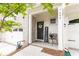 Inviting front porch with brick accents, 'WELCOME' sign and a cozy seating area, perfect for relaxing at 500 Garvin Dr, Woodstock, GA 30189