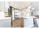 Bright kitchen boasts stainless appliances, white cabinets, and a convenient center island with pendant lighting at 500 Garvin Dr, Woodstock, GA 30189