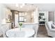 Bright kitchen with stainless steel appliances, white cabinets, a peninsula with bar seating and modern lighting at 500 Garvin Dr, Woodstock, GA 30189