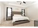 Spacious main bedroom features a tray ceiling, ceiling fan, carpet, and dual nightstands at 500 Garvin Dr, Woodstock, GA 30189