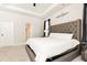 Serene main bedroom features a tufted headboard, tray ceiling, and plush carpeting for ultimate relaxation at 500 Garvin Dr, Woodstock, GA 30189