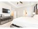 Spacious main bedroom featuring plush carpet, mirrored dresser and tray ceiling with fan at 500 Garvin Dr, Woodstock, GA 30189
