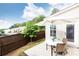 A charming patio with a table and chairs, shaded by a white umbrella, with green foliage in the background at 500 Garvin Dr, Woodstock, GA 30189