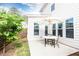 Cozy backyard patio with patio table and umbrella adjacent to home with green foliage and blue sky at 500 Garvin Dr, Woodstock, GA 30189