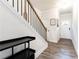 Staircase featuring wooden treads, modern black railings, and a view of the bright, open entryway at 500 Garvin Dr, Woodstock, GA 30189