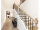 Elegant staircase with wooden treads, iron railings, and a view of the open-concept living area at 500 Garvin Dr, Woodstock, GA 30189