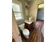 Cozy bathroom featuring a toilet, sink, vanity, and a window with a wooded view at 7260 Cox Rd, Cumming, GA 30028