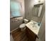 Small bathroom featuring a toilet, sink, vanity, and towel rack with a functional layout at 7260 Cox Rd, Cumming, GA 30028