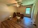 Bedroom with warm wood floors, and a desk with a mirror at 7260 Cox Rd, Cumming, GA 30028
