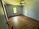Empty bedroom with light blue walls, wood floors, and natural light at 7260 Cox Rd, Cumming, GA 30028