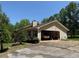 View of the house and carport showing the backyard trees at 7260 Cox Rd, Cumming, GA 30028