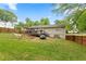 Fenced backyard with a deck, outdoor seating, a hammock, and raised garden beds for relaxation at 984 Ridgecrest Se Dr, Smyrna, GA 30080