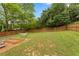 Expansive, grassy fenced backyard with a hammock and garden bed, perfect for recreation and gardening at 984 Ridgecrest Se Dr, Smyrna, GA 30080